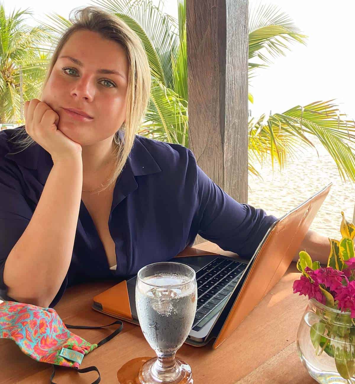 A woman sitting at a table with a laptop. 