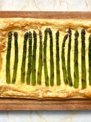 Easy asparagus tart on a wooden serving board.