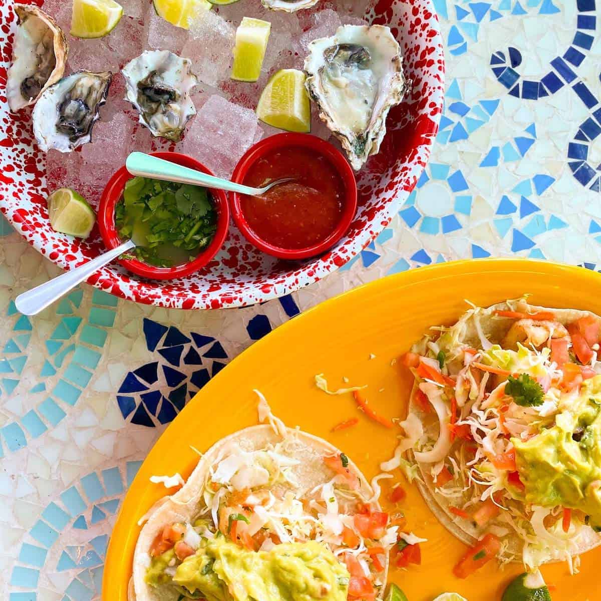 A plate of oysters and tacos. 