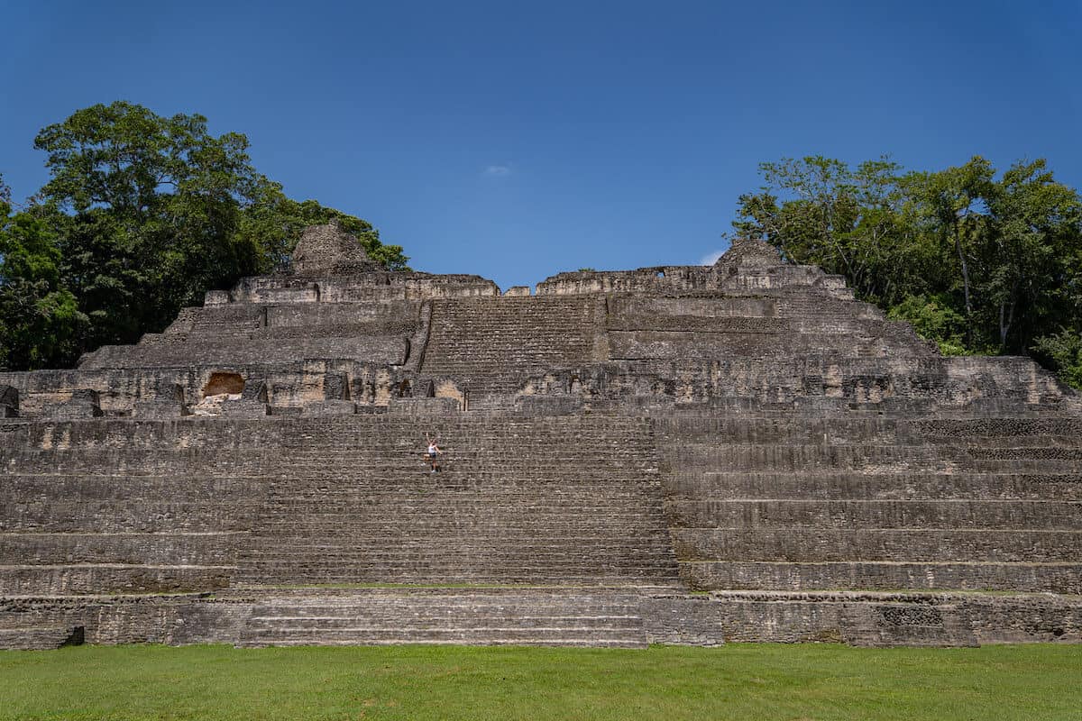 A person standing on the Sky Palace at Caracol Mayan ruins. 