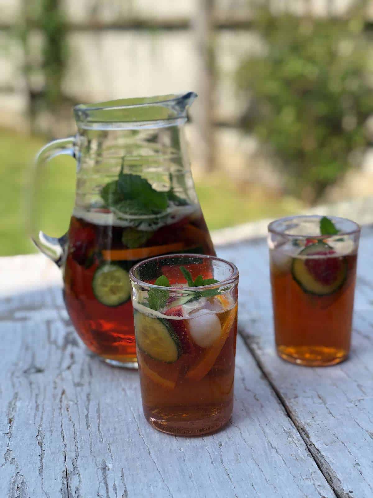  A jug of pimms on a wooden table. 
