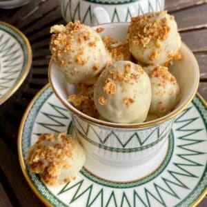 White chocolate cheesecake balls in a coffee cup.