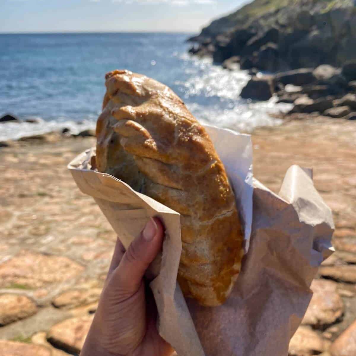 A Cornish pasty on the beach in Cornwall 