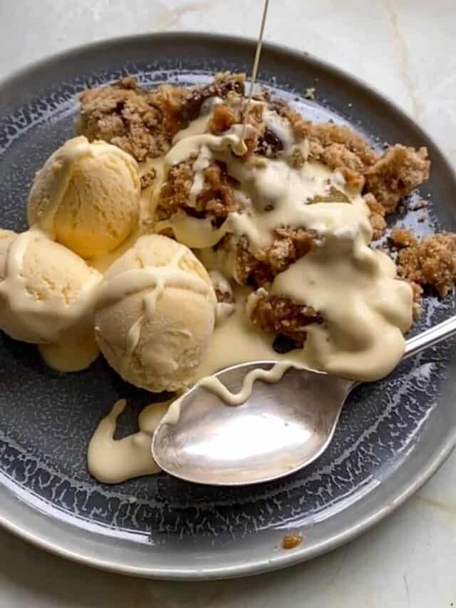 greengage and hazelnut crumble with scoops of vanilla ice cream and cream poured on top. This is one of the best British Christmas desserts.
