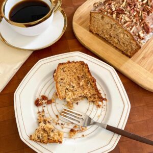 A serving of banana bread with pecans and a maple glaze