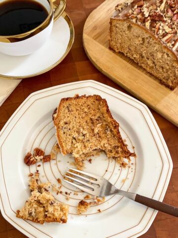 A serving of banana bread with pecans and a maple glaze