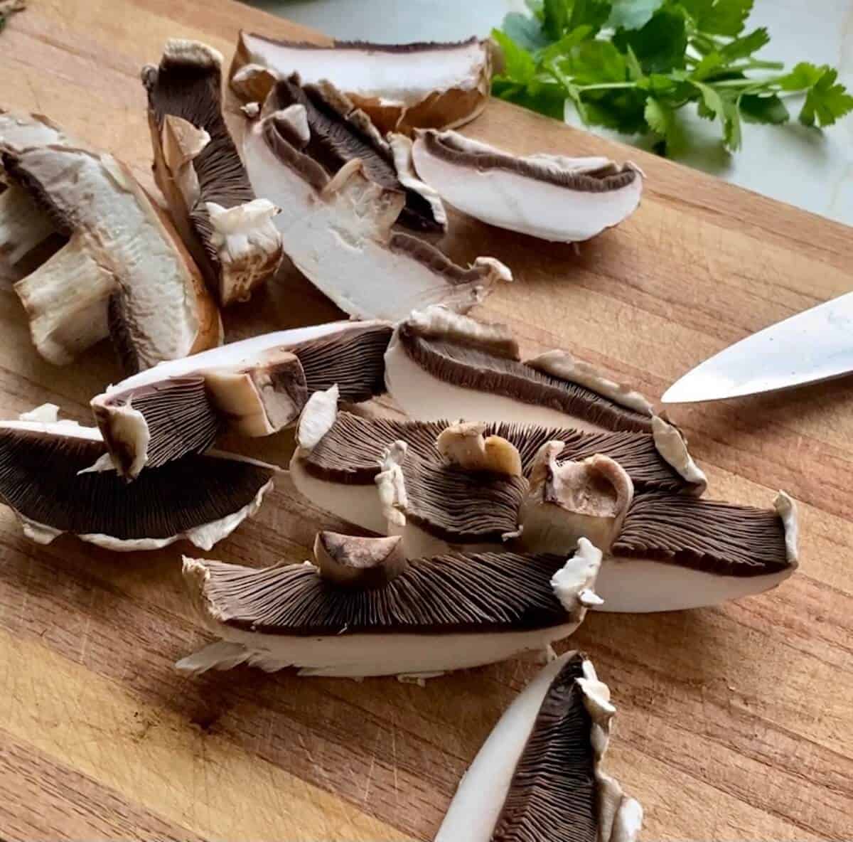 sliced portobello mushrooms on a chopping board