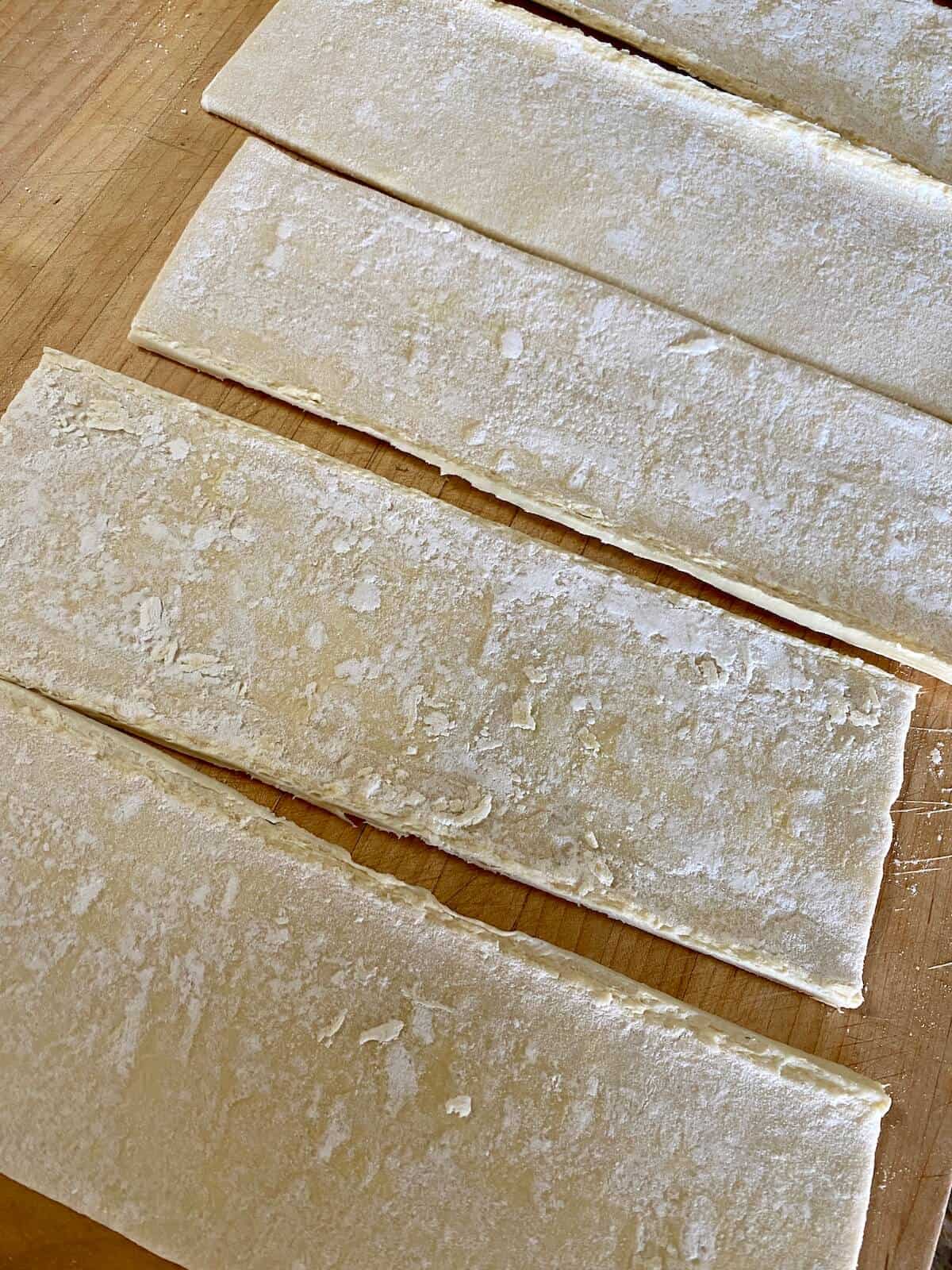 puff pastry cut into strips to make gourmet sausage rolls 