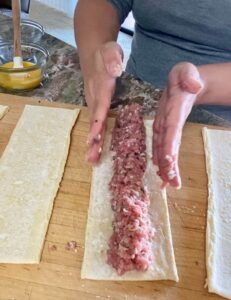Shaping the pork mince into a long sausage down the length of the puff pastry