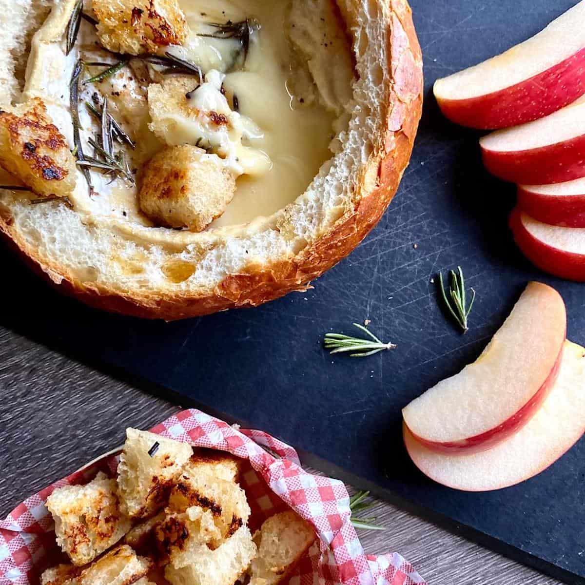 baked camembert with honey with apple slices on a canapé tray