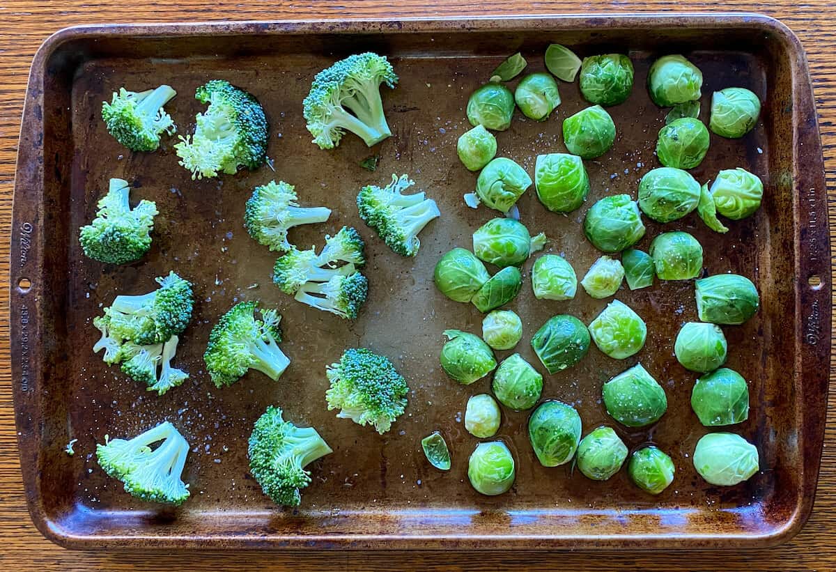 raw Brussel sprouts and broccoli on an oven tray