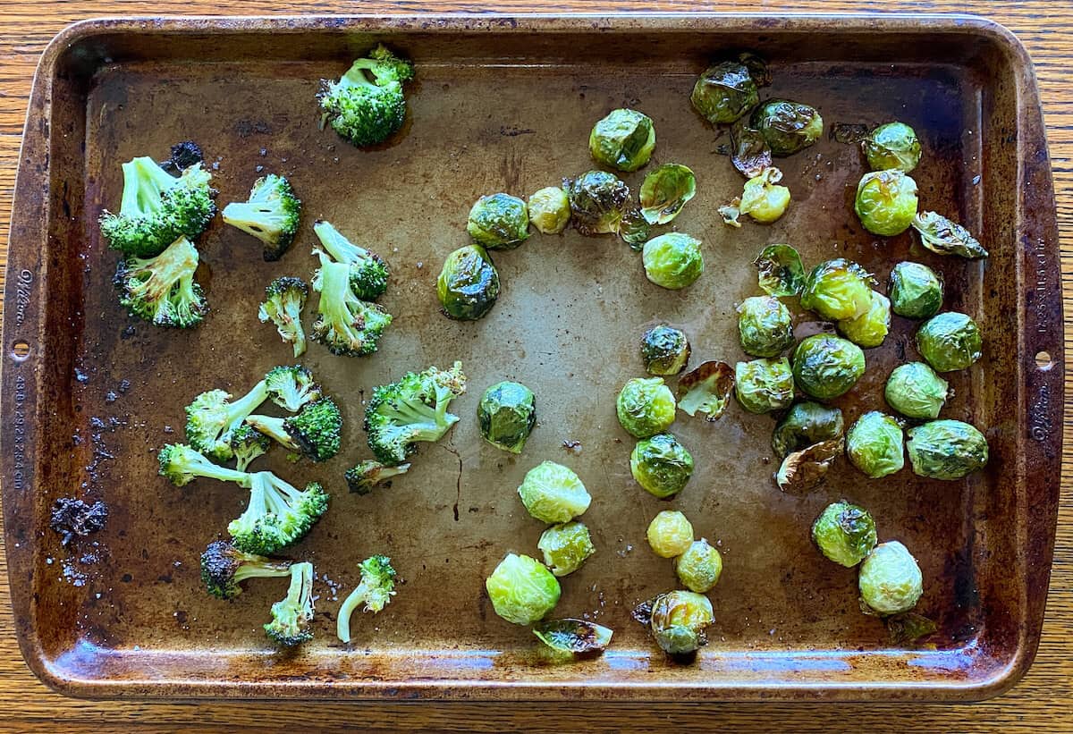 oven roasted Brussel sprouts and broccoli on an oven tray 
