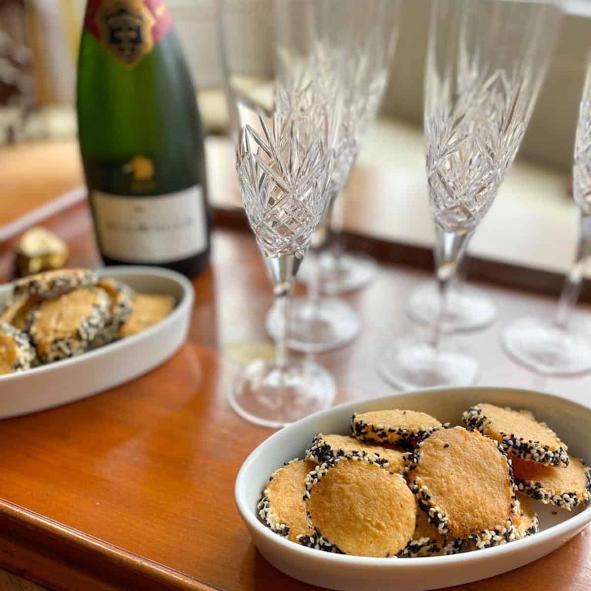 Spicy biscuits with parmesan cheese served as a snack on a tray with champagne 