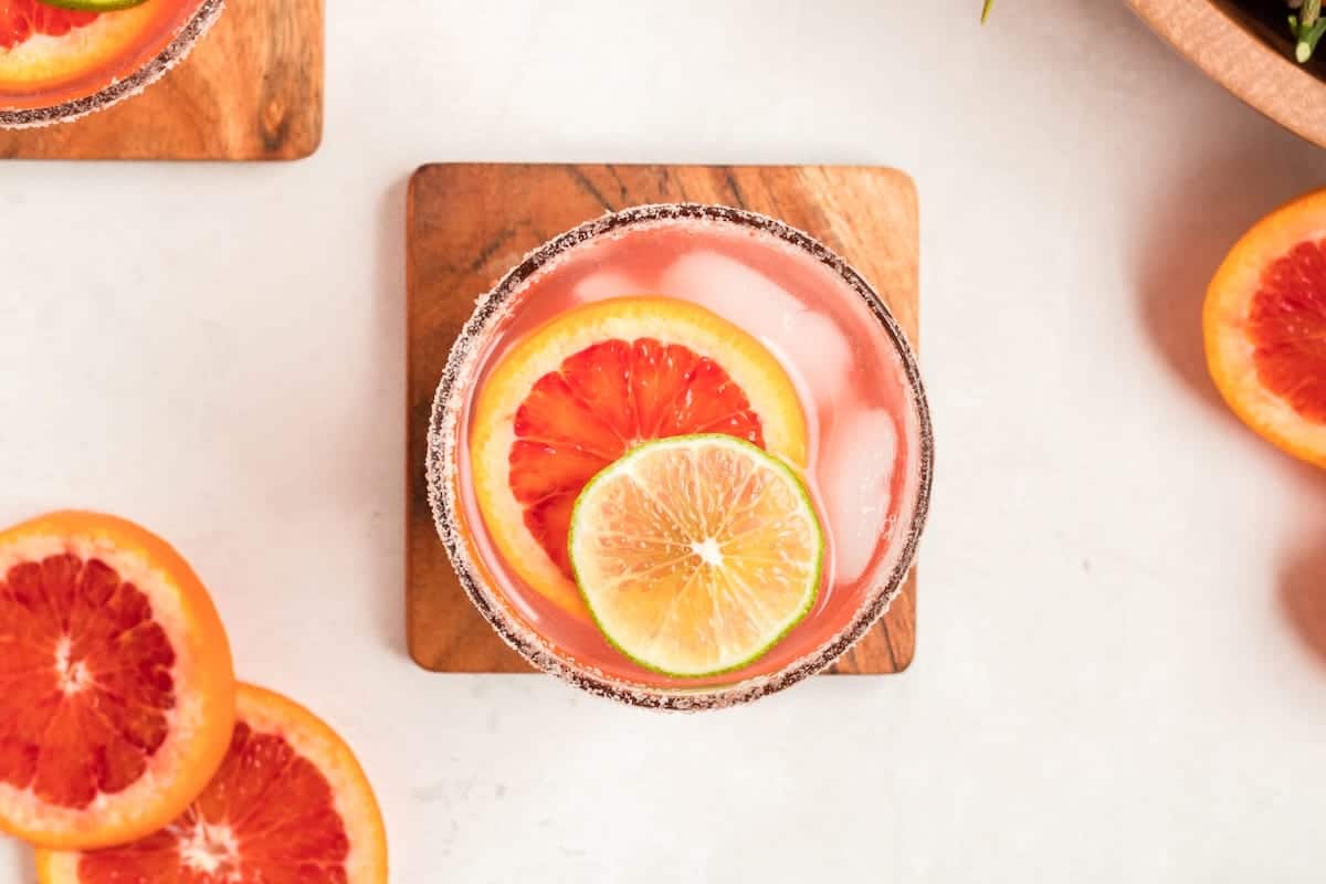 Blood orange margarita with salt rim and fresh lime