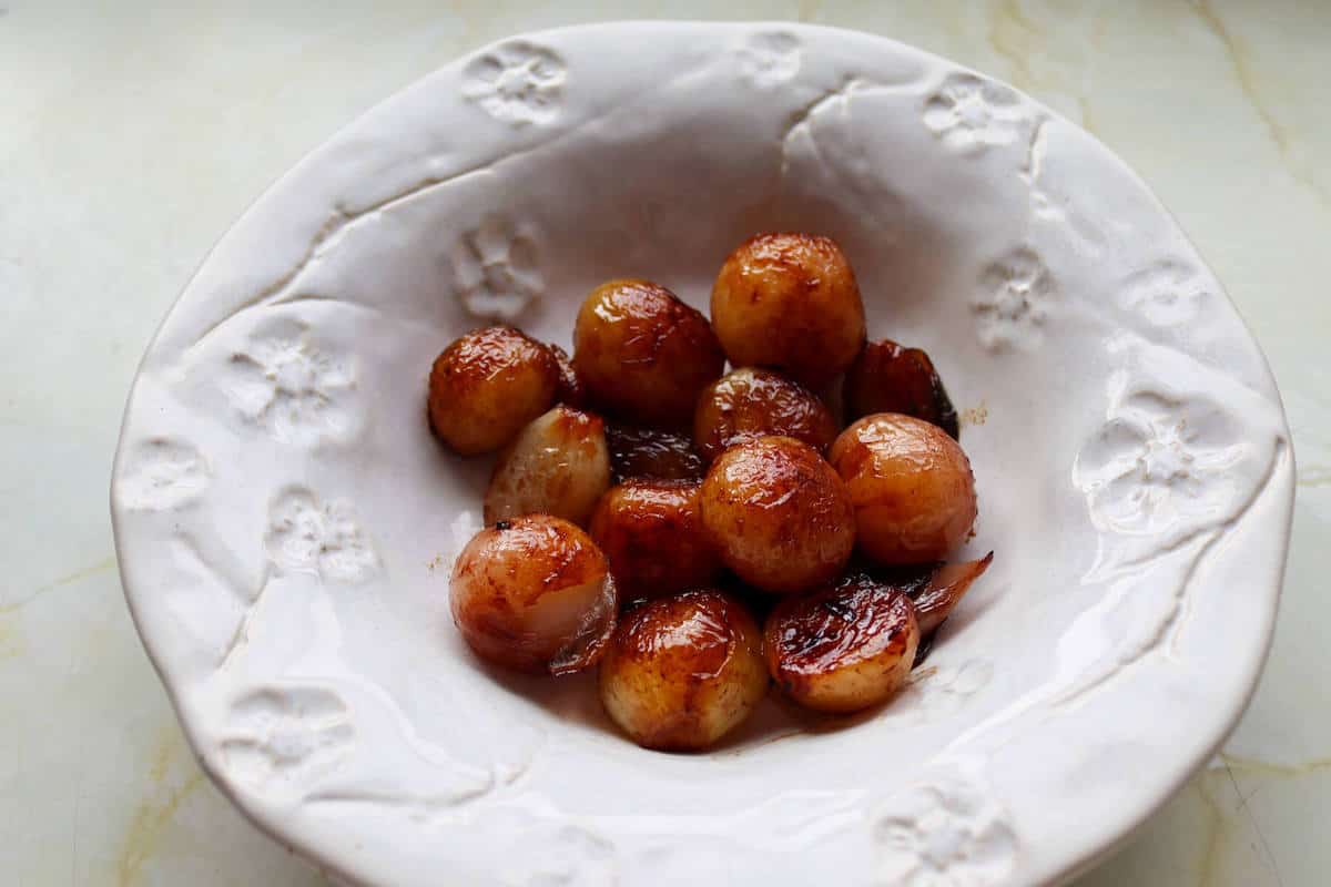 Browned cooked shallots in a bowl 