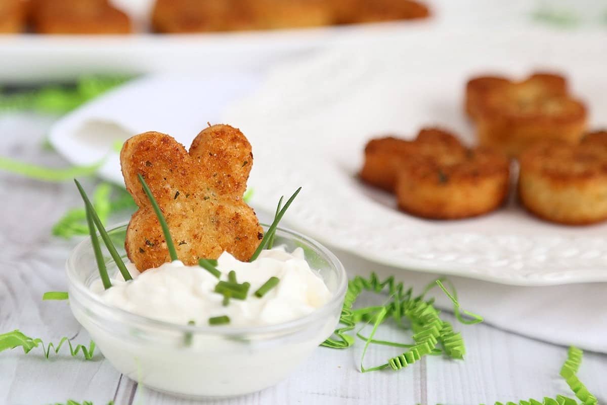 Bunny shaped easter canapés on a serving plate with a dipping sauce 