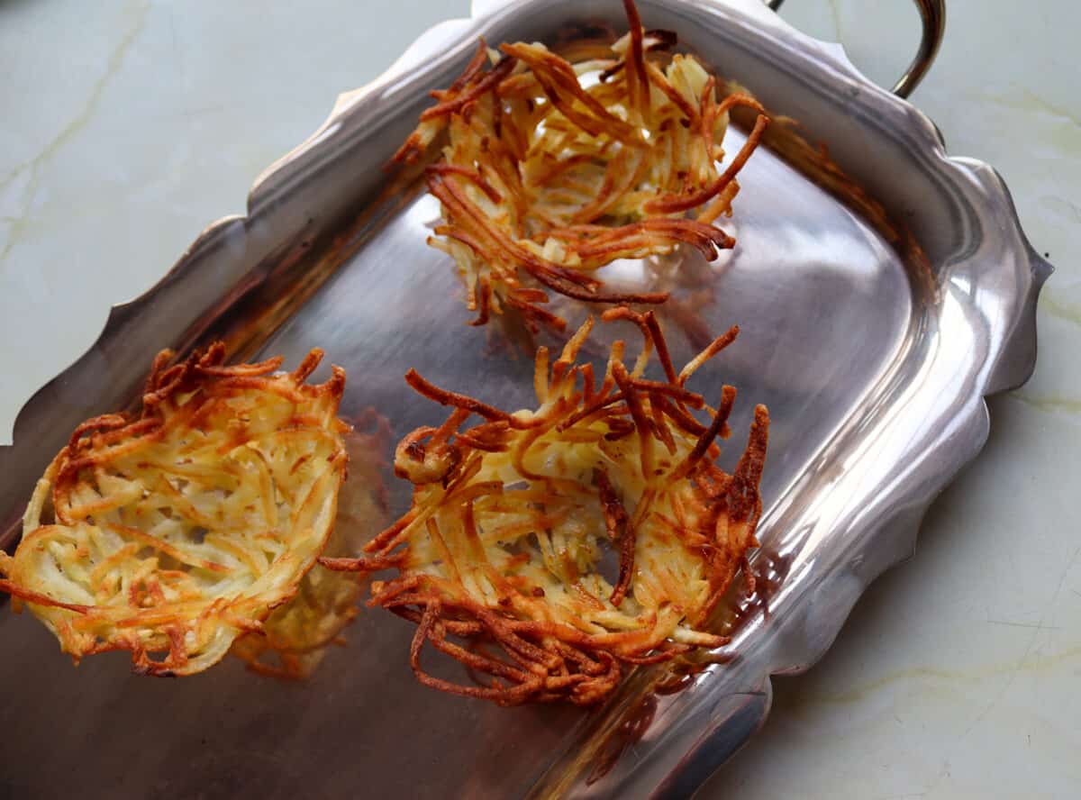 grated potato nests on a serving tray