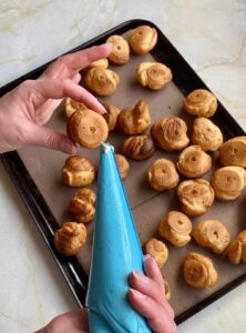 filling savoury profiteroles using a piping bag