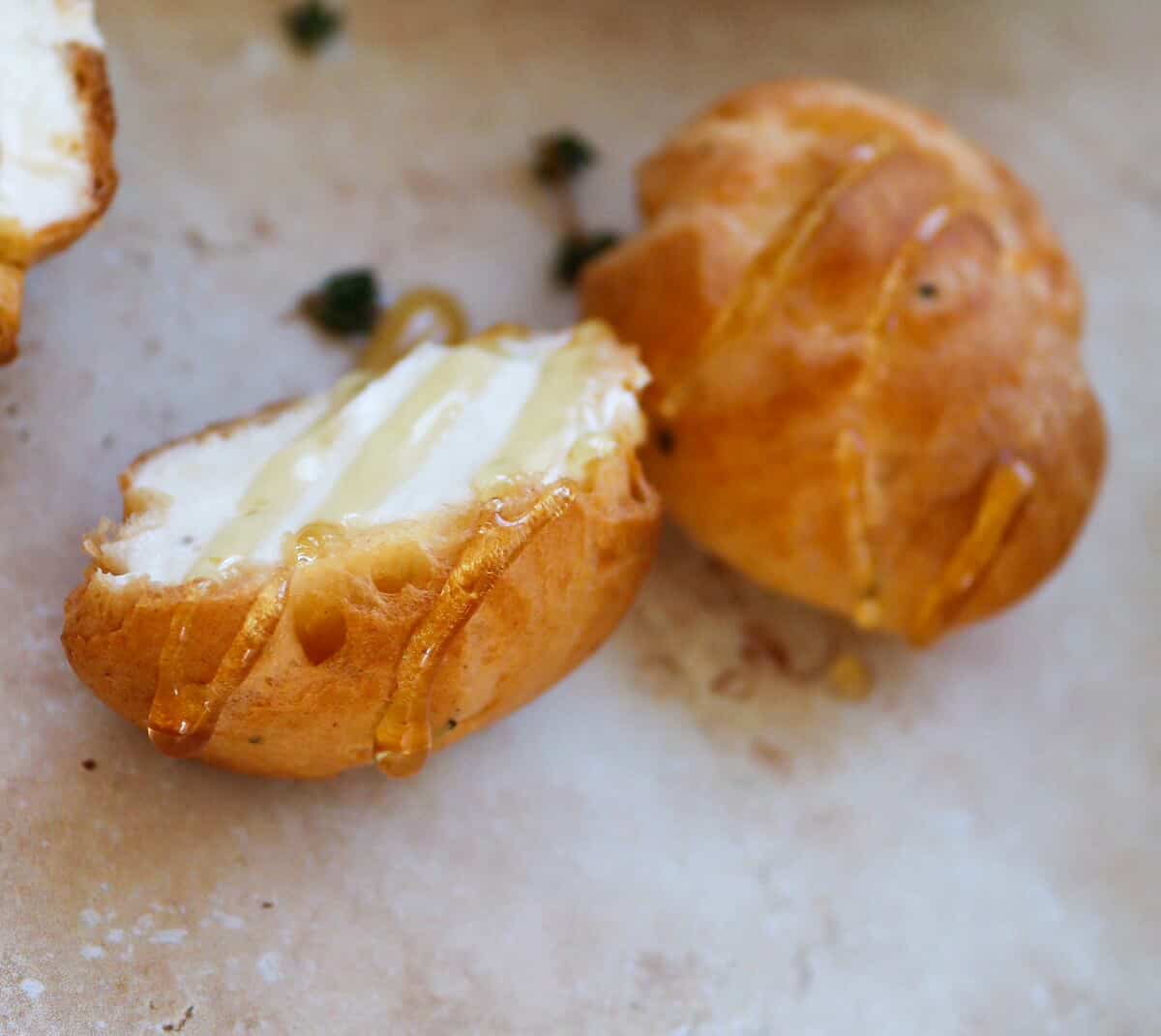 a savoury profiterole cut in half and drizzled with honey