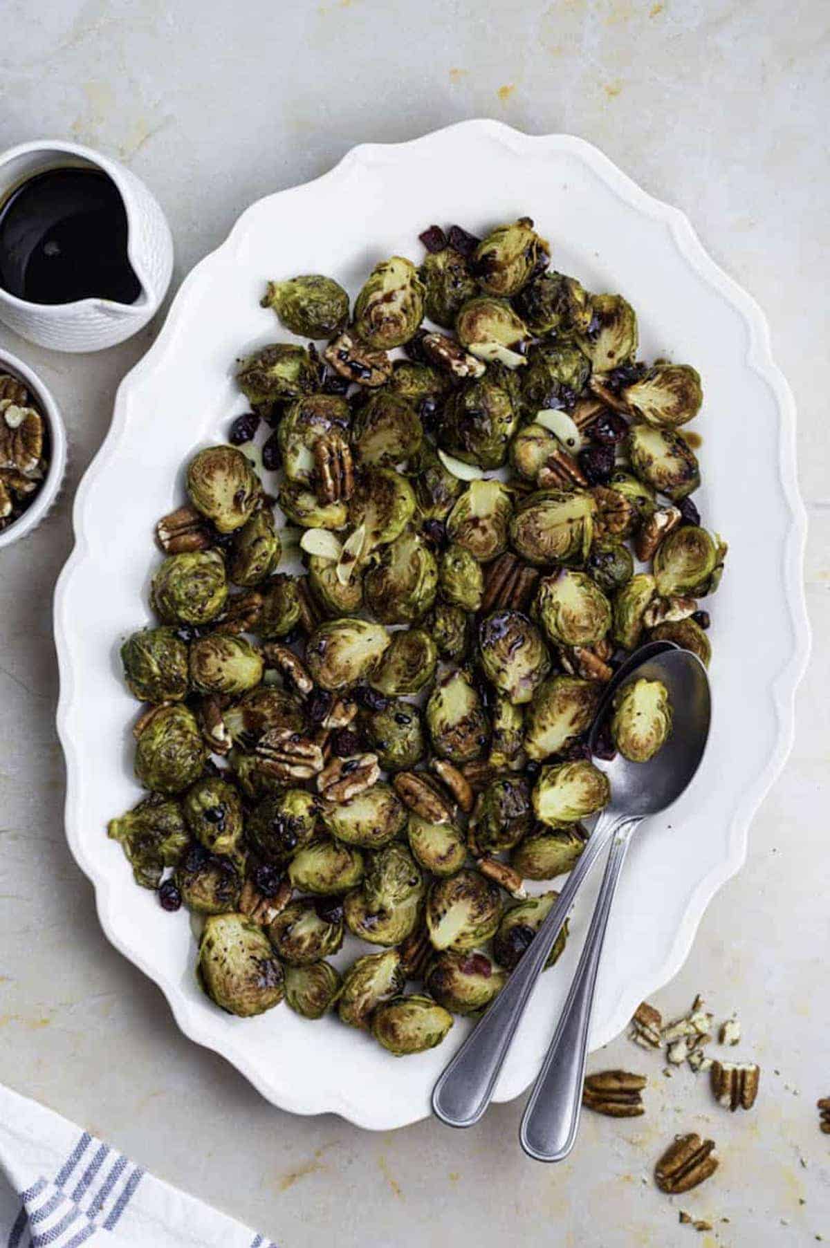 A serving dish on the Easter dinner table with Brussel sprouts and walnuts 