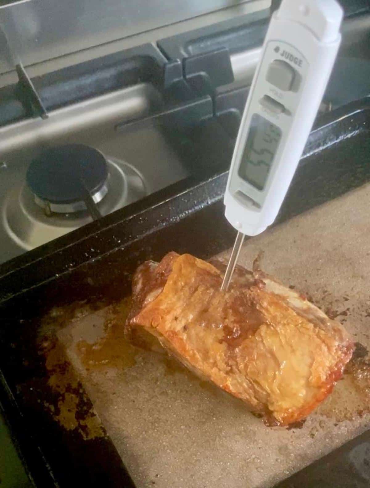 Measuring the temperature of the lamb rump with a meat thermometer