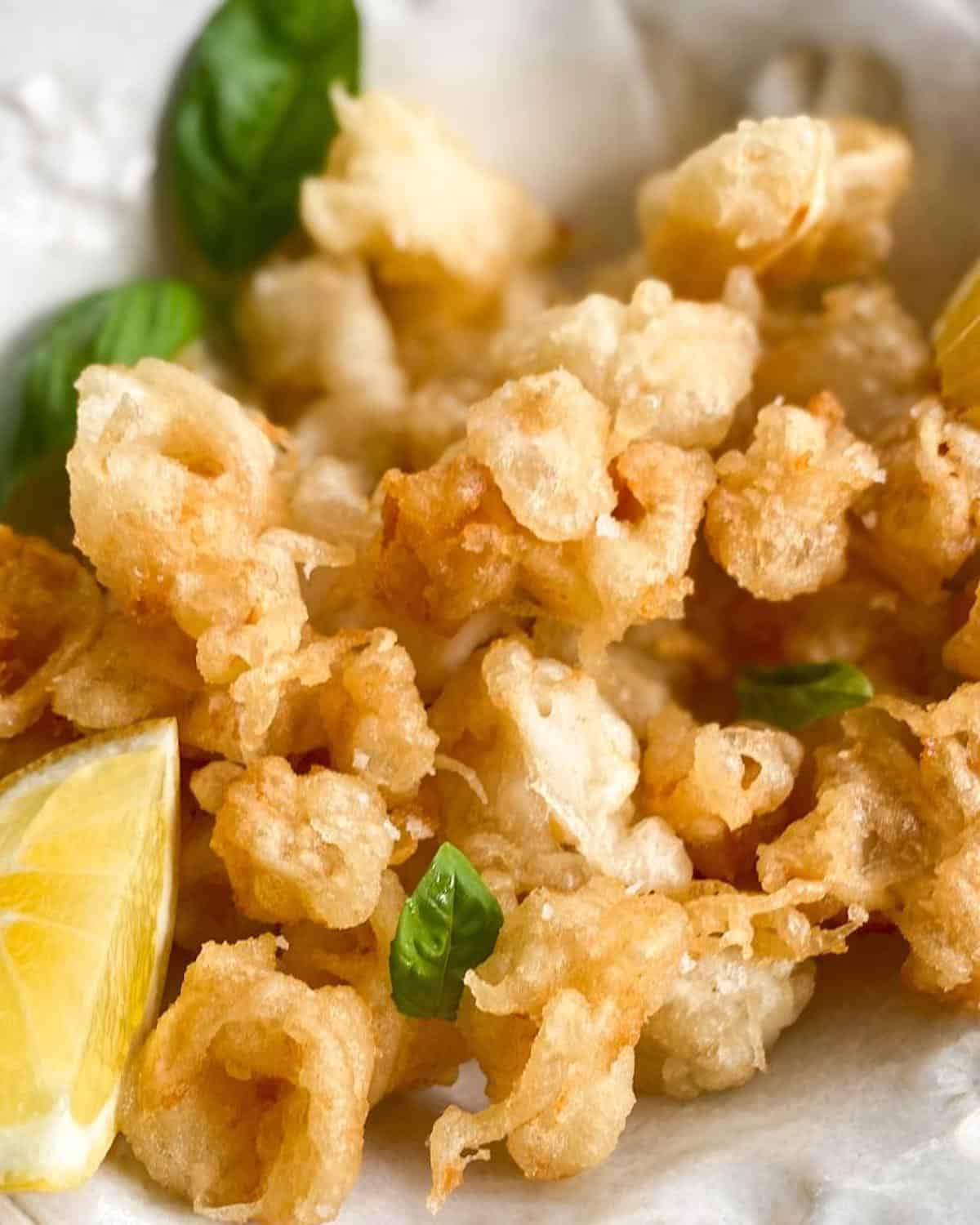 Tempura fried baby squid popcorn calamari in a serving bowl 