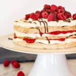 A layered raspberry torte on a cake stand