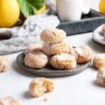 Lemon and almond biscotti on a plate surrounded by lemons.