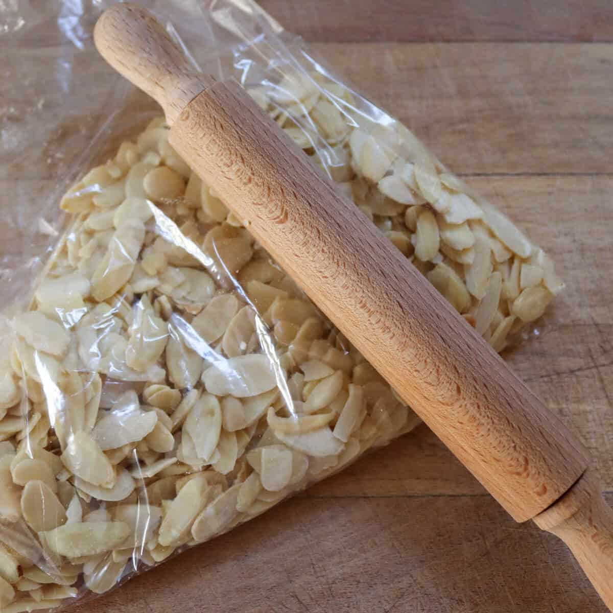 flaked almonds in a ziplock bag and a rolling pin which will be used to crush them. 