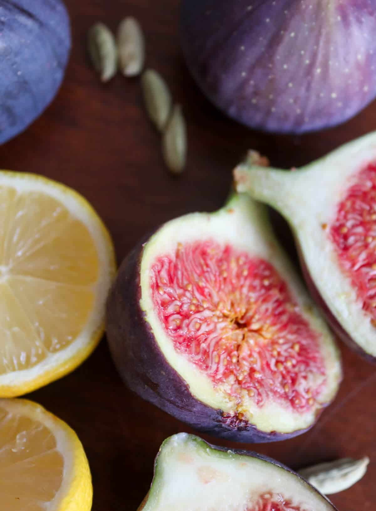A close up of figs, lemon and cardamom seeds. 