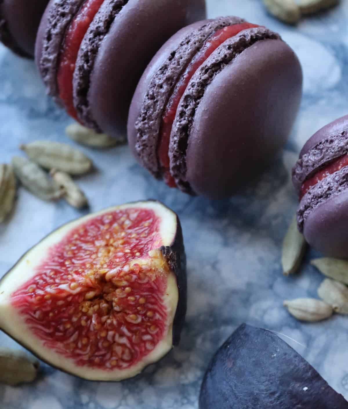 Macarons and figs on a serving plate. 