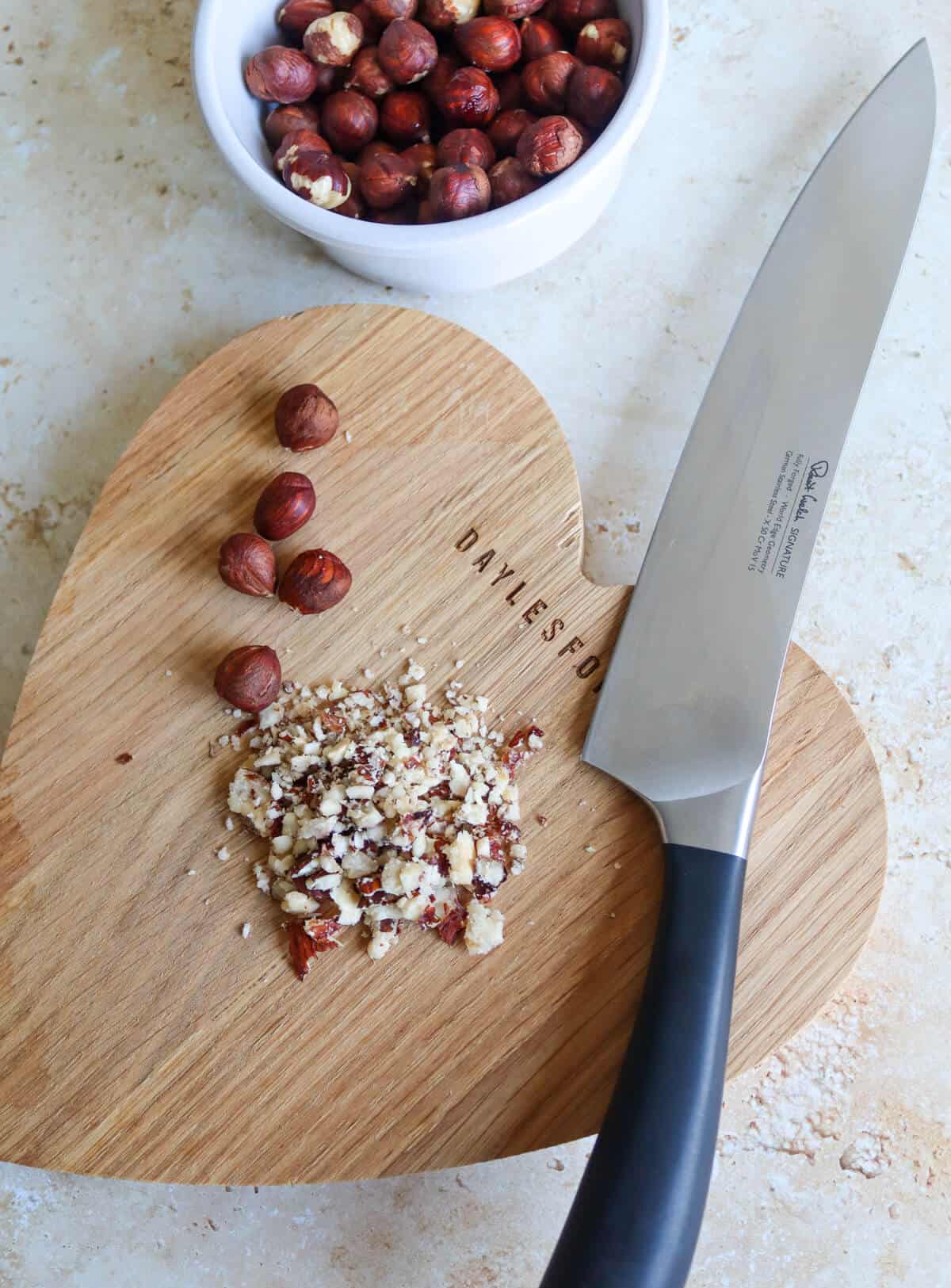 Chopped hazelnuts on a wooden board. 