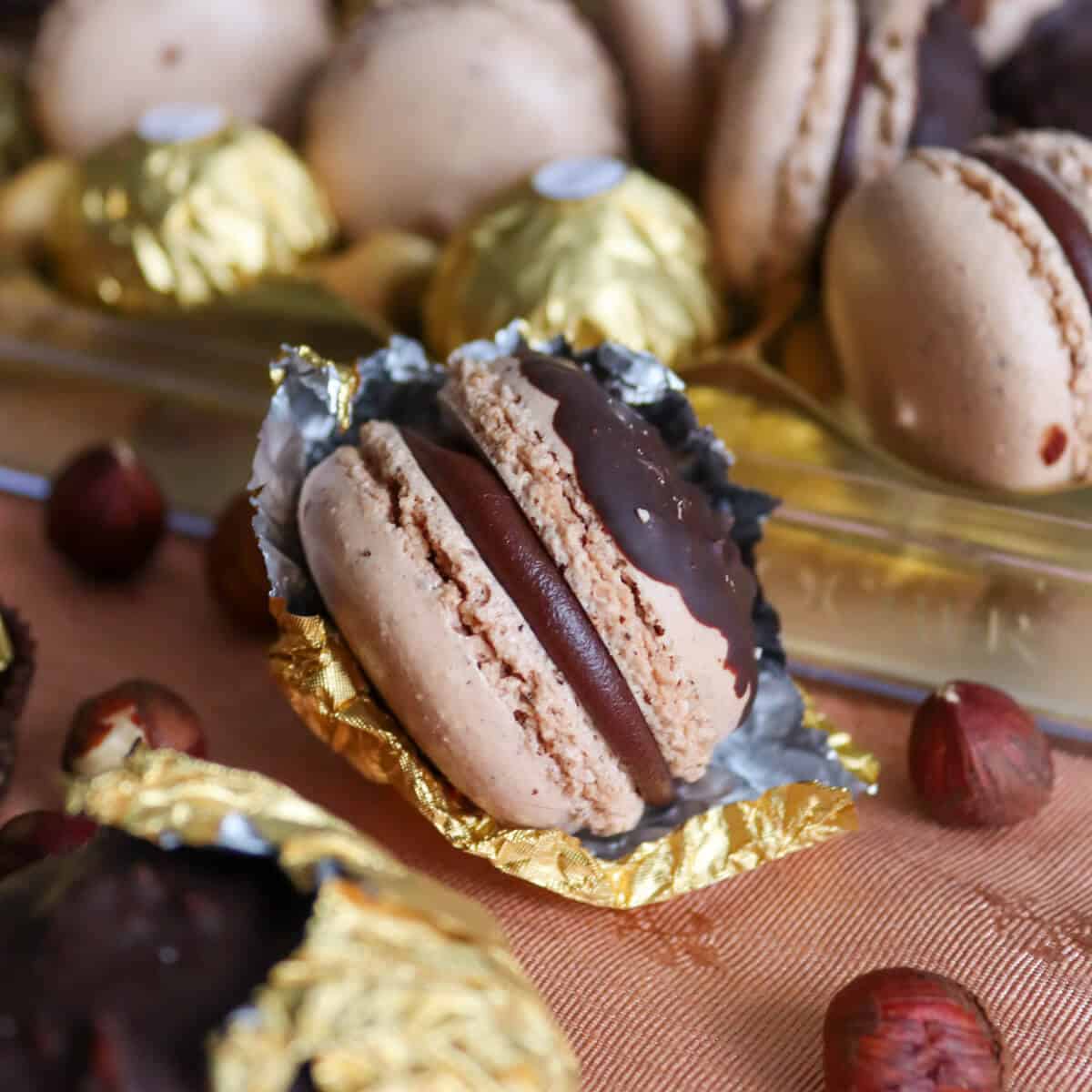 A gold foil wrapper with a fall macaron inside it.