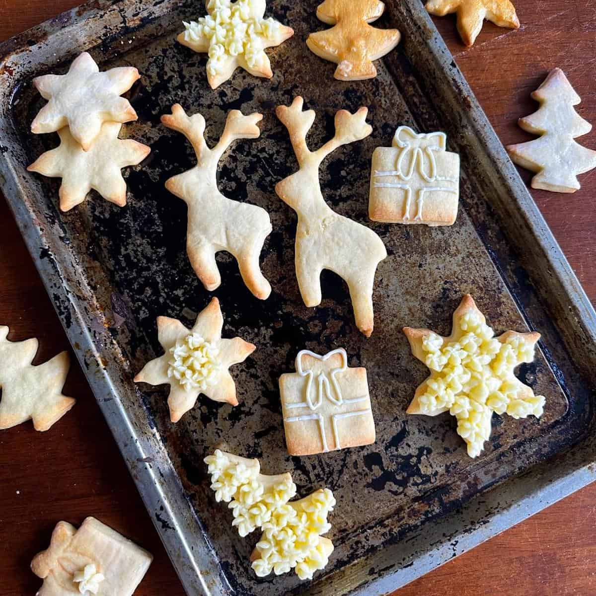 Decorated Christmas cookies on a baking tray.