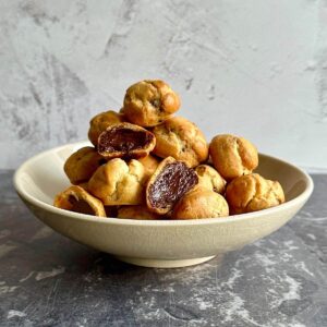 A bowl of chocolate truffle profiteroles.