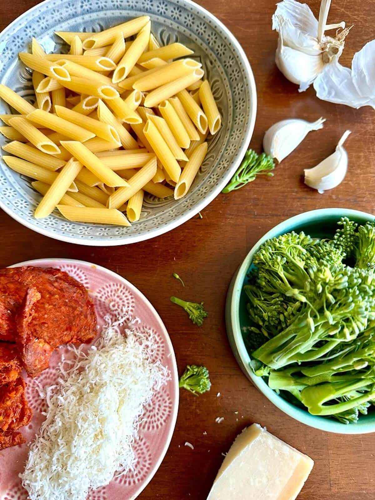 Spicy-Sausage-Broccolini-Pasta-ingredients-in-bowls-on-a-table.