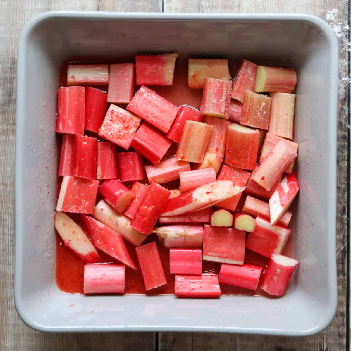 An oven proof dish full of pieces of rhubarb.