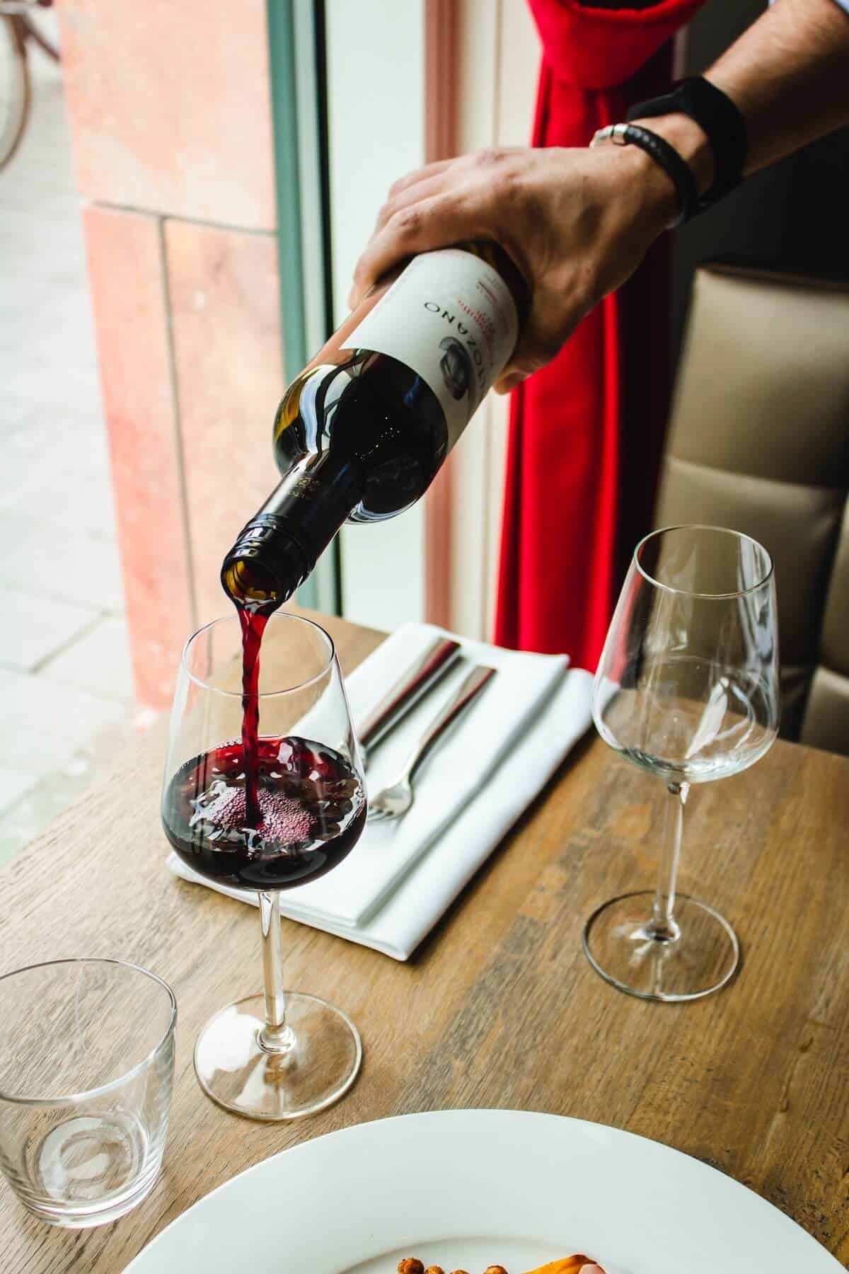 A glass of wine being poured.