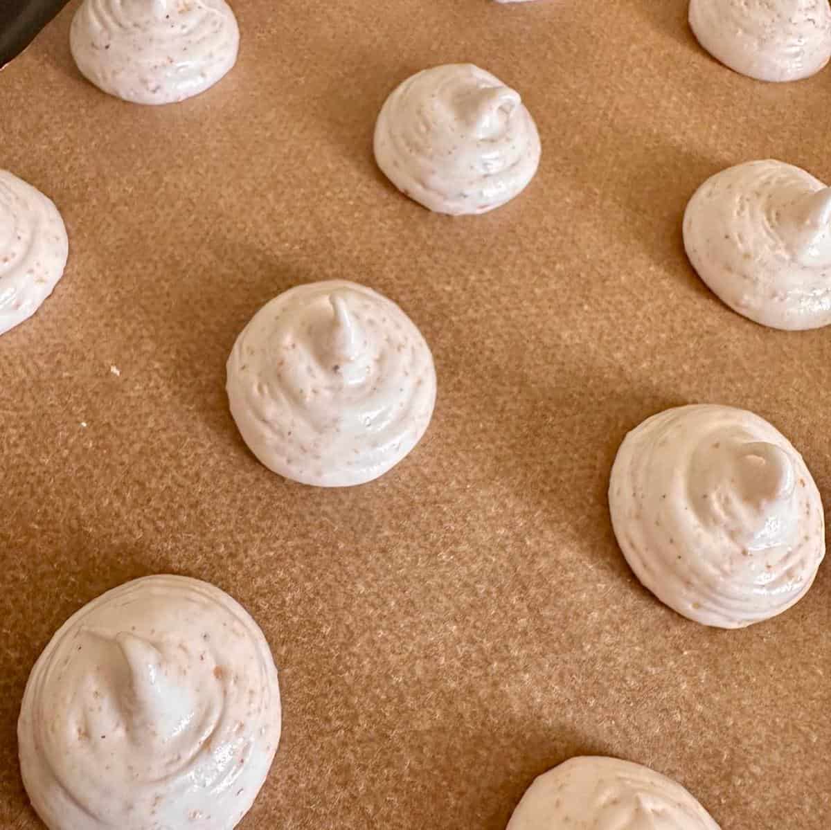 Hazelnut-Meringue-Cookies-piped-on-baking-sheet.
