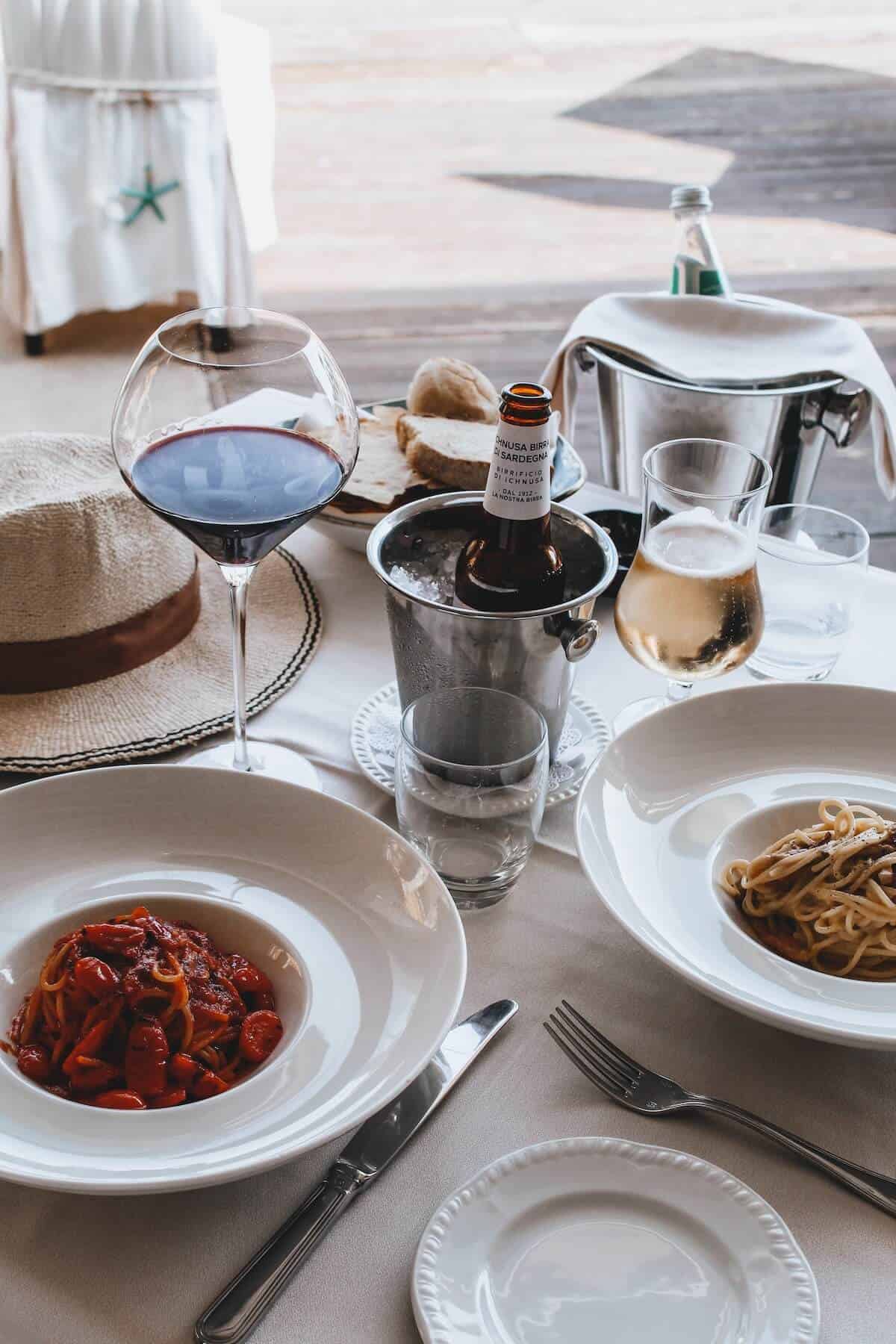 Image-shows-pasta-and-wine-on-a-table.