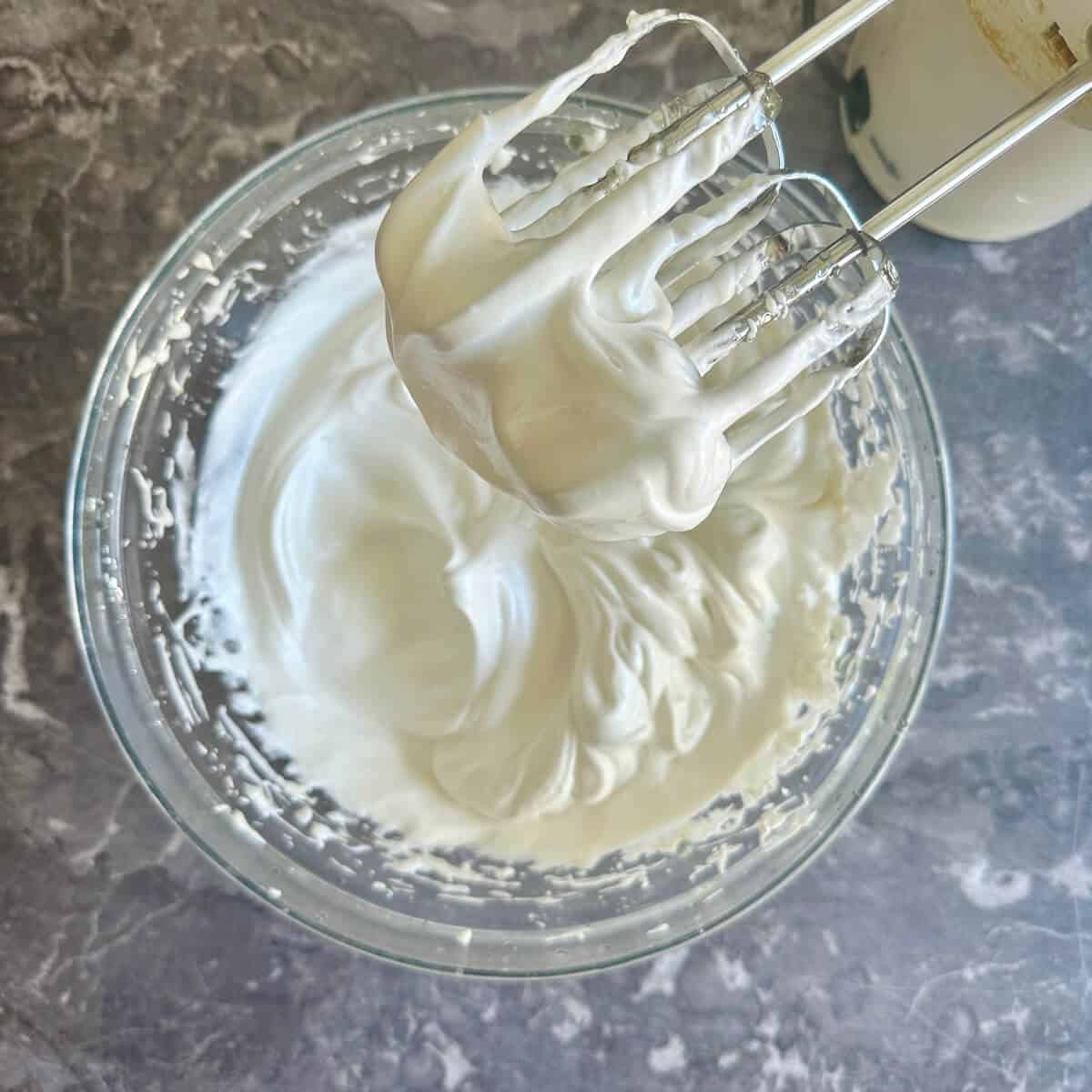 A bowl of glossy white Italian meringue. 