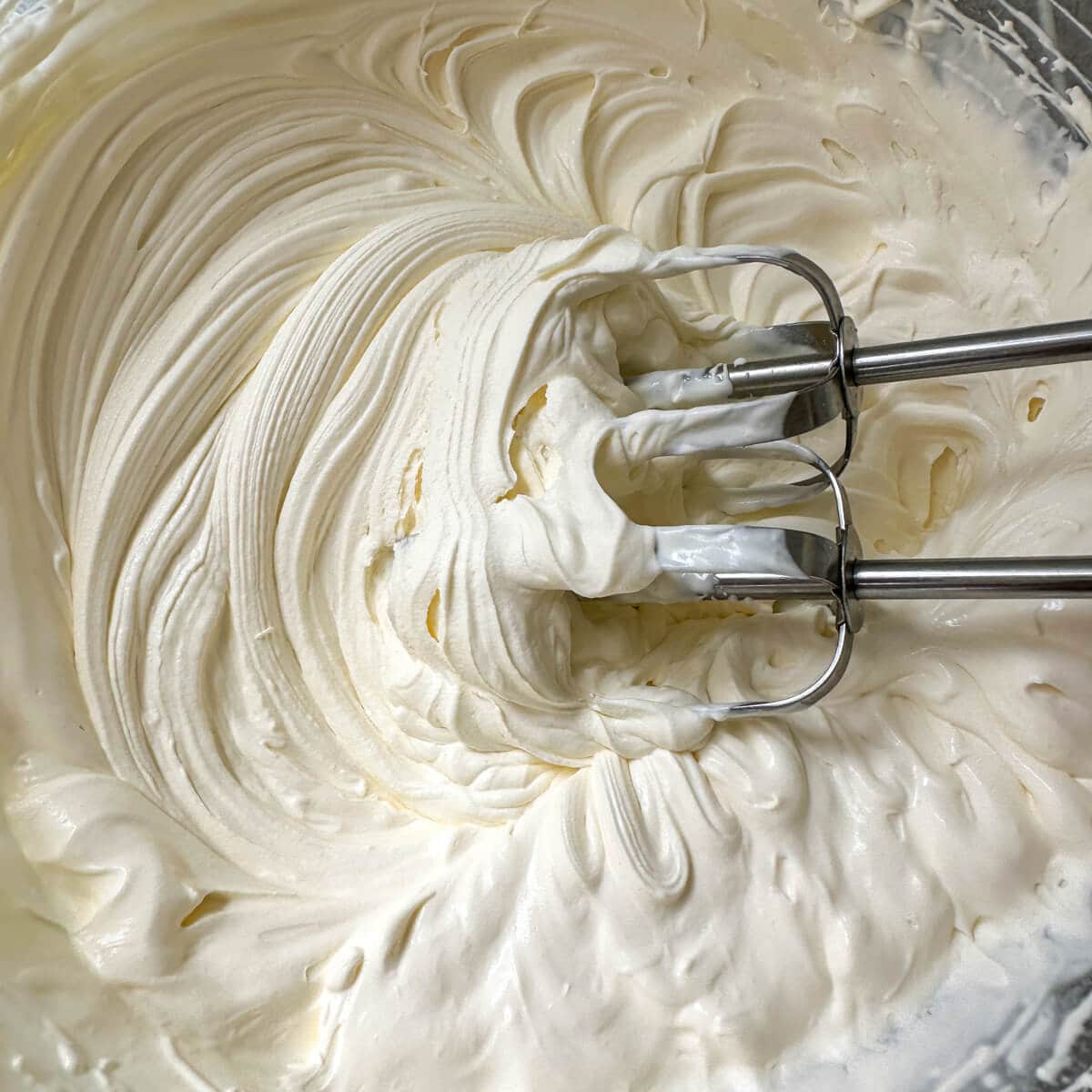 Whipped cream in a mixing bowl. 