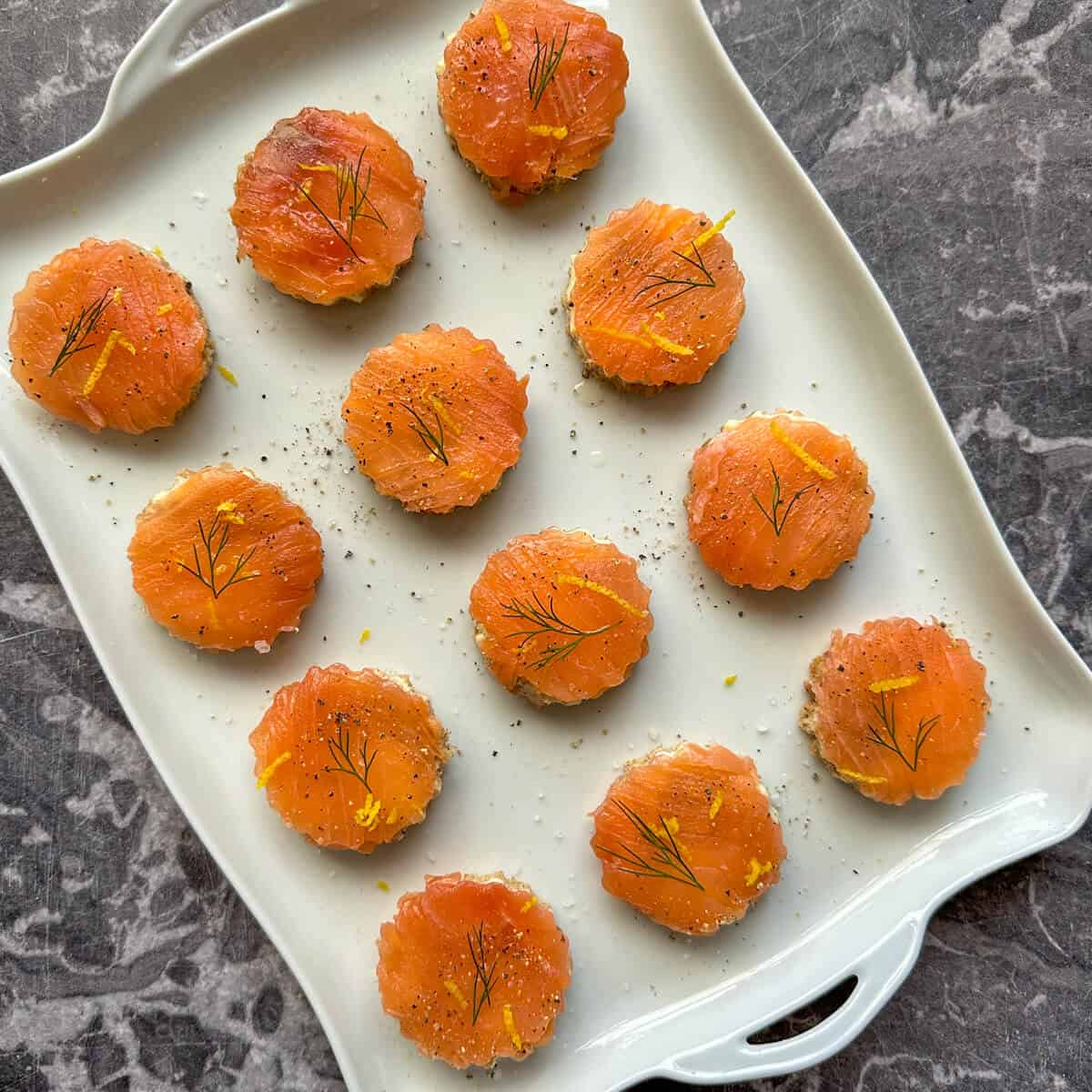 Smoked salmon canapes on a serving platter. 