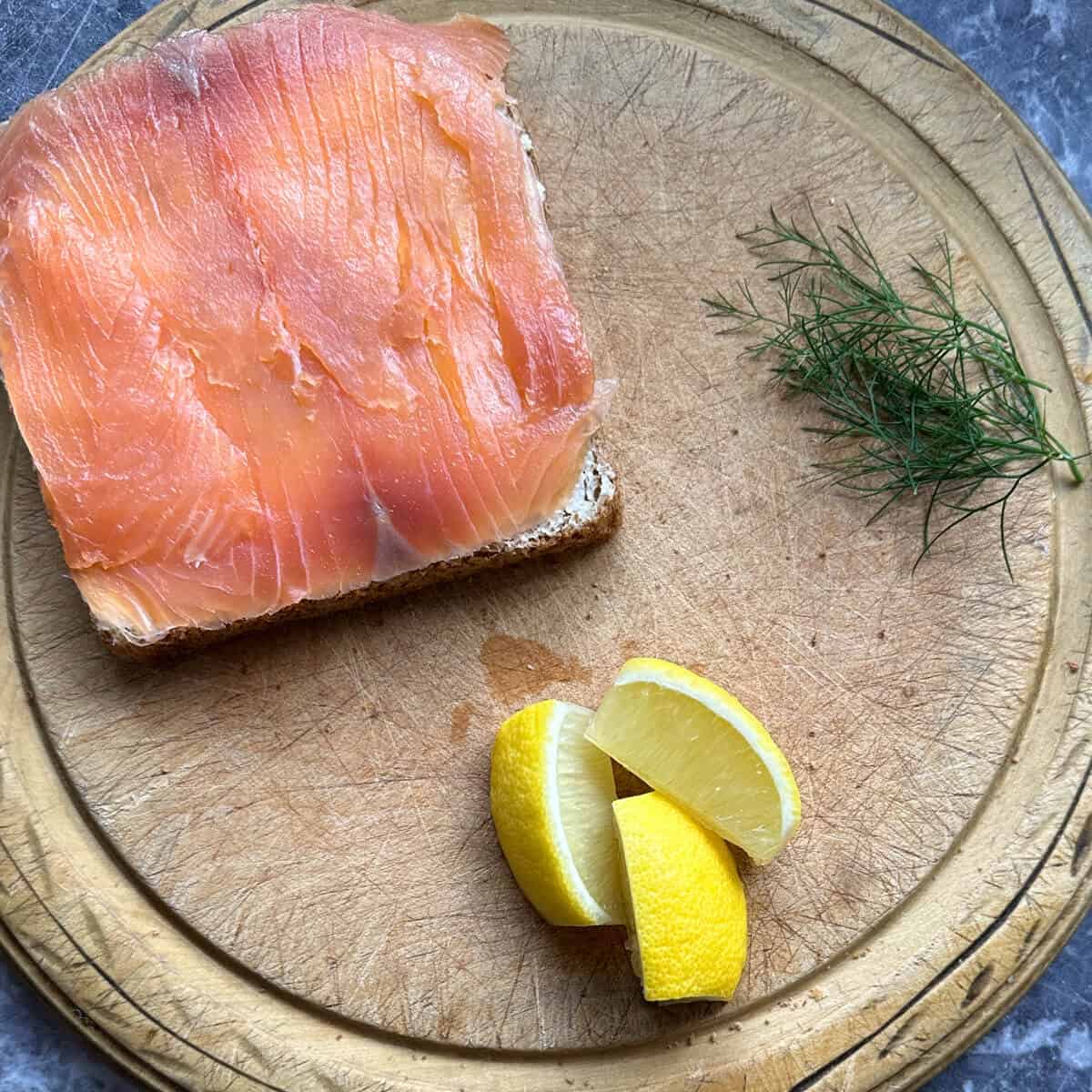Slices of smoked salmon on a piece of bread. 