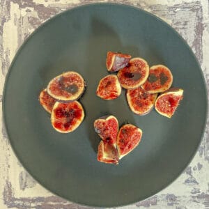 Bruleed figs on a plate.