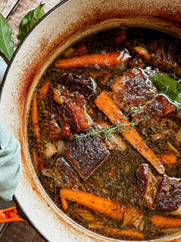 A Dutch Oven Filled With Slow Cooked Beef Short Ribs Braised In Beer.