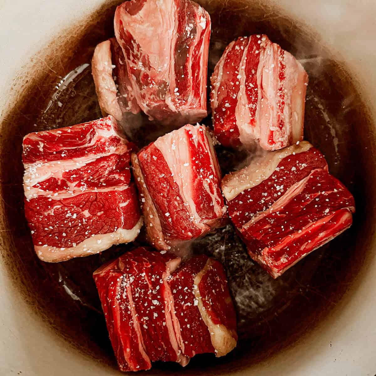 Searing short ribs in a Dutch oven. 
