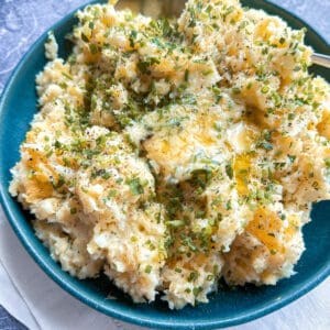 Buttery herb and root vegetable mash in a serving bowl.