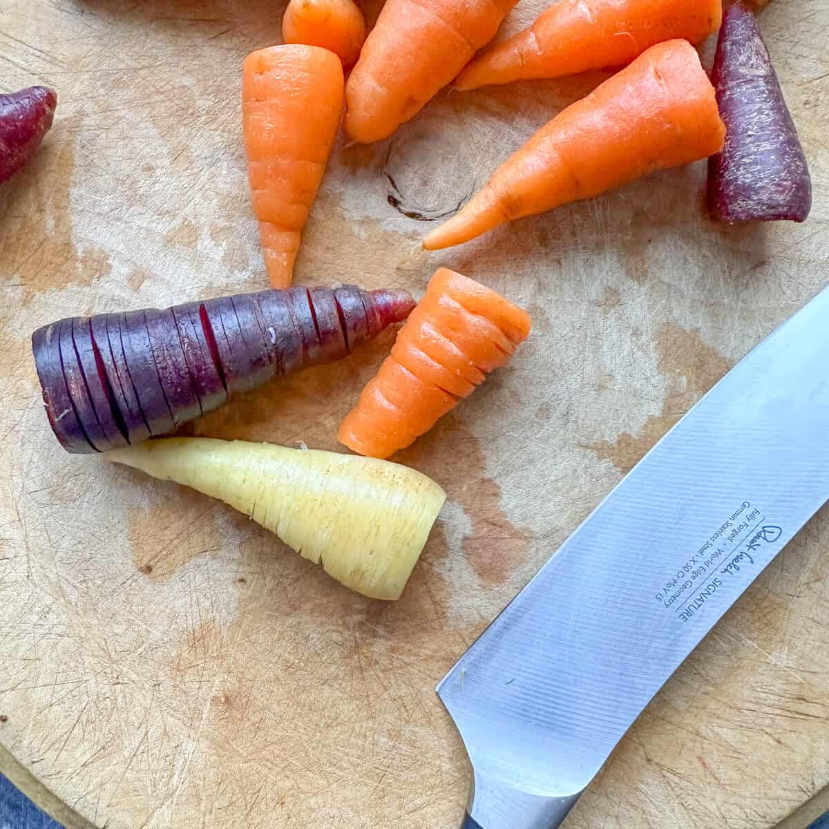 Carrots on a cutting board with a knife. 