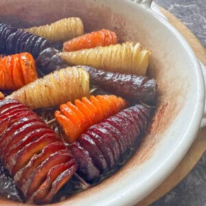 Roasted hasselback carrots in an oven dish.